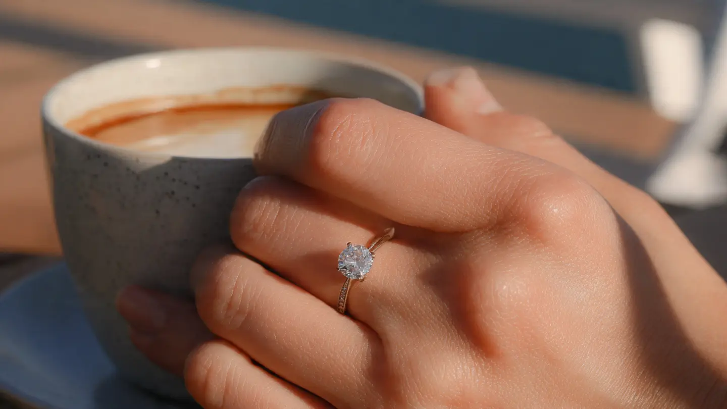  Low-profile bezel set solitaire ring in platinum for active lifestyle.